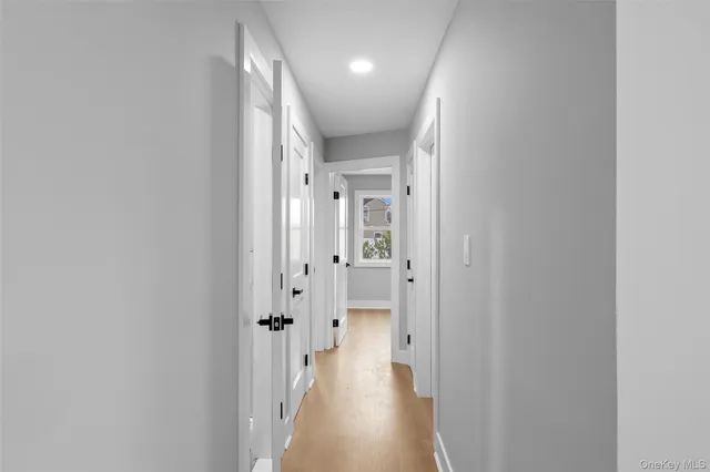 a view of a hallway with wooden floor