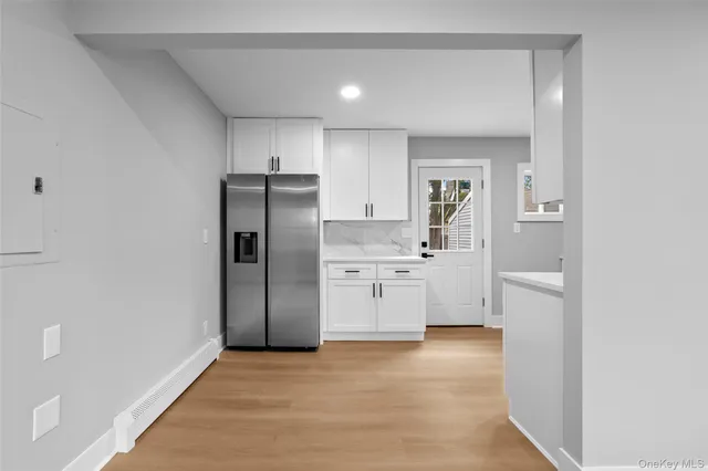 a kitchen with a refrigerator and a sink