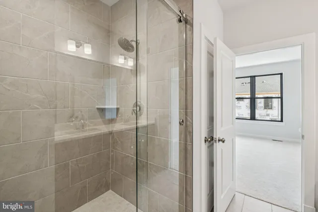 a view of a hallway with stairs and wooden floor