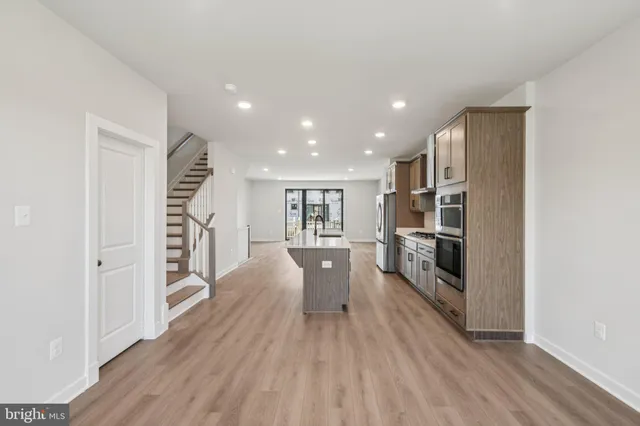a view of a kitchen cabinets and wooden floor