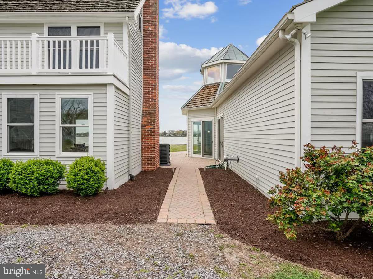21642 Chicken Point Road Tilghman, MD 21671 - Photo 55 of 63 a view of a house with a yard and potted plants
