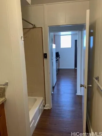 a bathroom with a granite countertop toilet sink and mirror