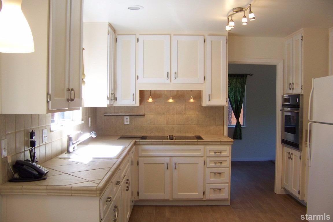 165 Pinion Road Markleeville, CA 96120 - Photo 15 of 34 a kitchen with stainless steel appliances granite countertop a sink stove and refrigerator