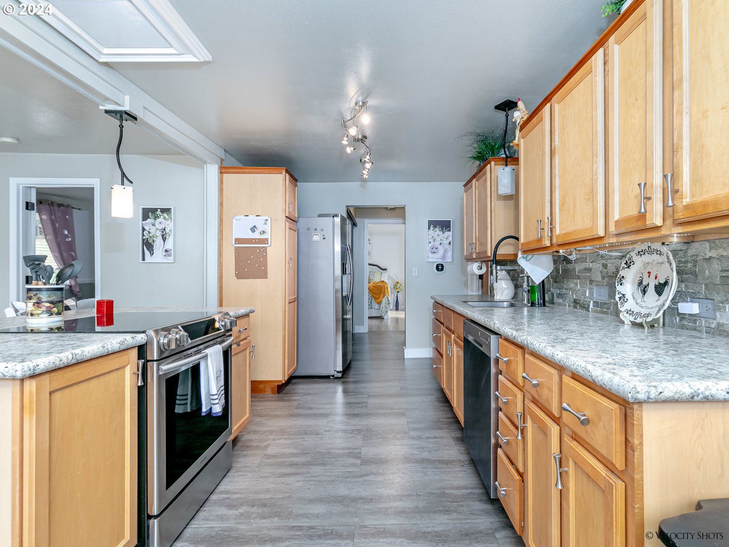 40170 Southeast Fish Hatchery Road Sandy, OR 97055 - Photo 5 of 30 a kitchen with stainless steel appliances granite countertop a sink a stove and a refrigerator