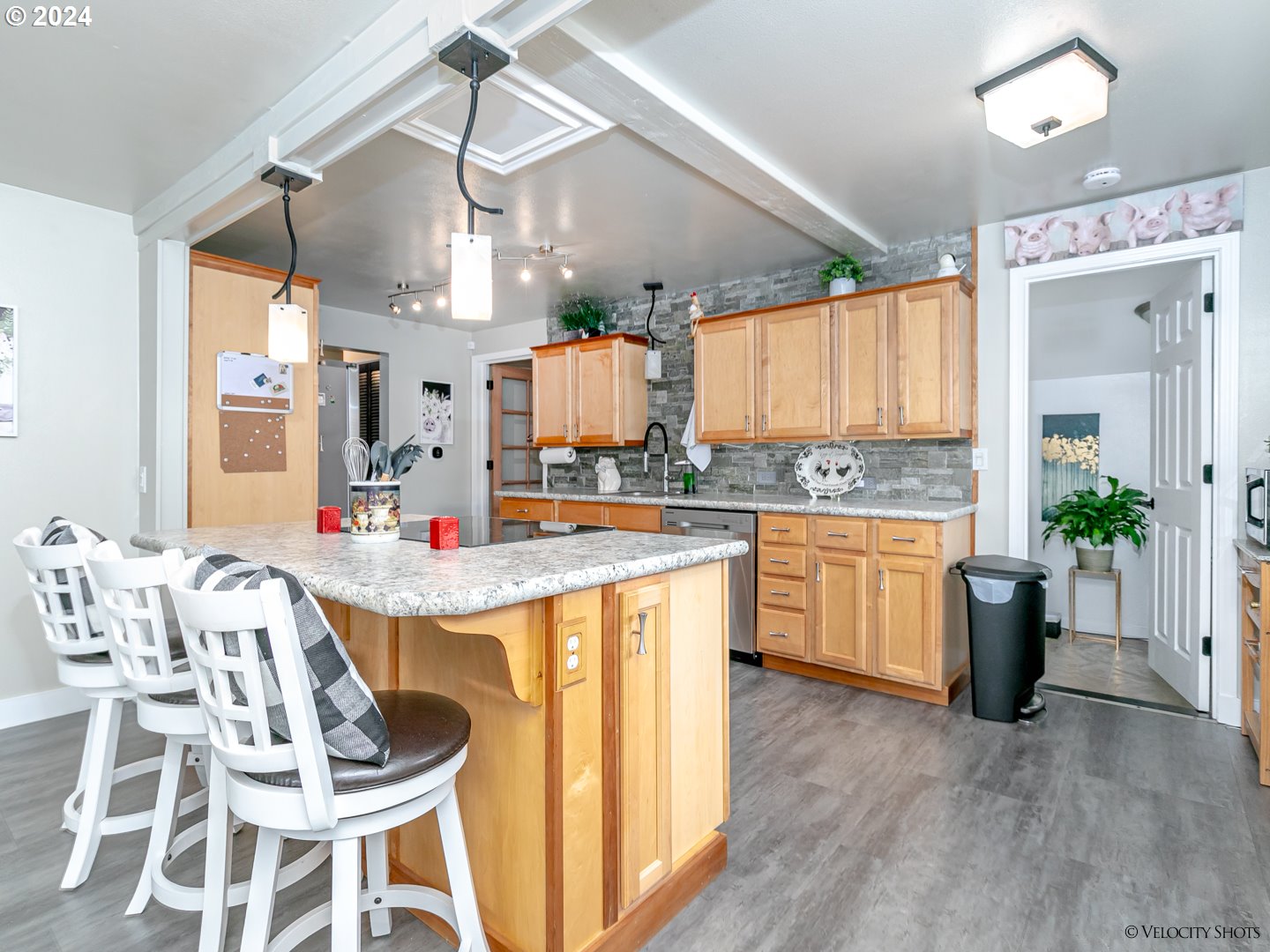40170 Southeast Fish Hatchery Road Sandy, OR 97055 - Photo 6 of 30 a open kitchen with stainless steel appliances granite countertop a sink dishwasher and a dining table with wooden floor