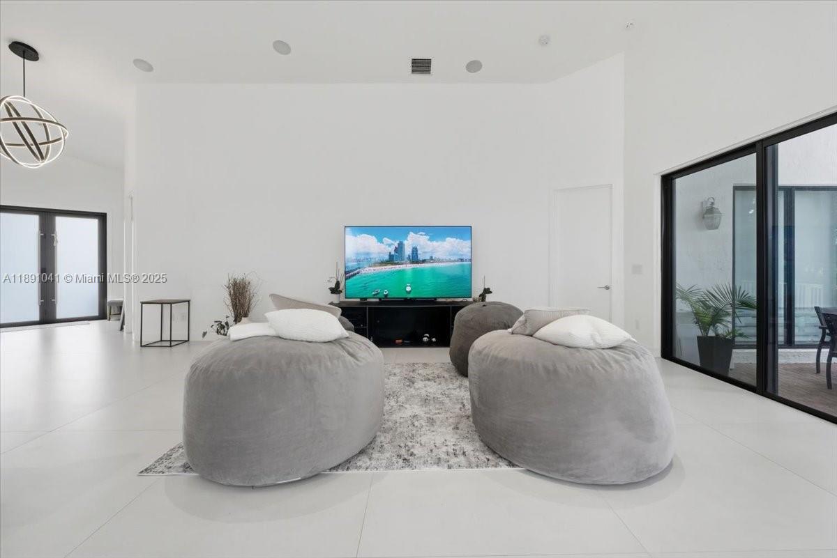 1441 154th Avenue Pembroke Pines, FL 33027 - Photo 11 of 37 a living room with furniture and a window