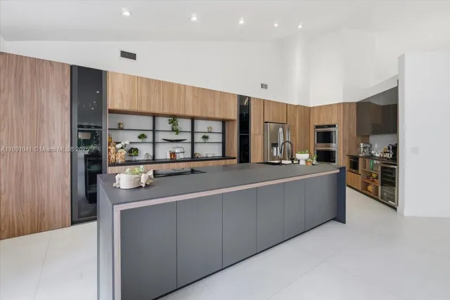 a large kitchen with lots of counter top space and wooden floor