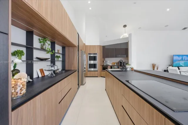a kitchen with stainless steel appliances a refrigerator and a stove top oven