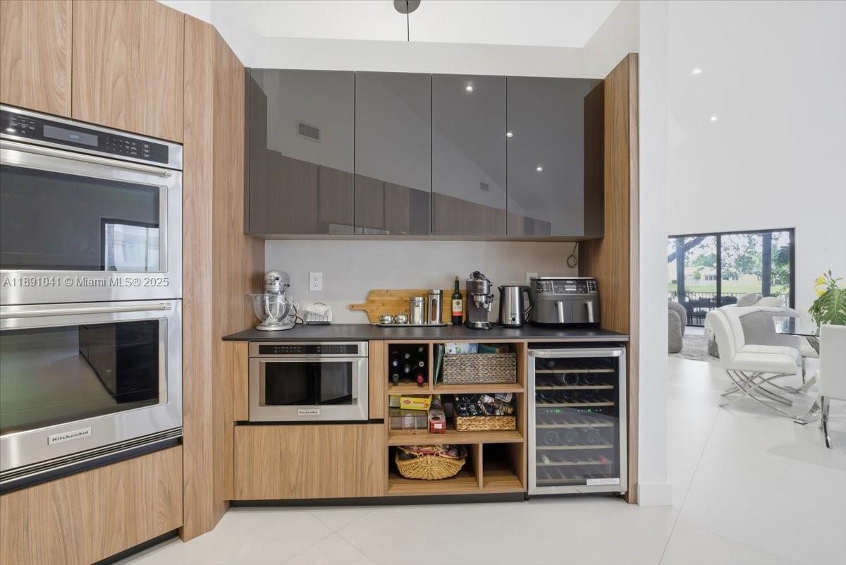 1441 154th Avenue Pembroke Pines, FL 33027 - Photo 17 of 37 a kitchen with a stove and a microwave
