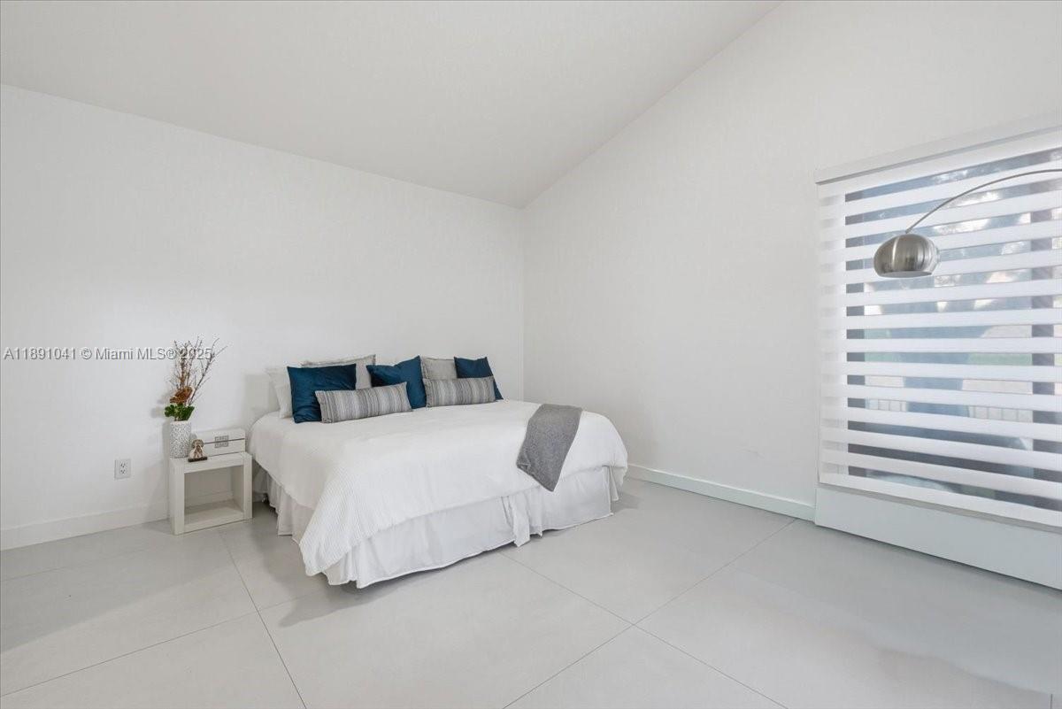 1441 154th Avenue Pembroke Pines, FL 33027 - Photo 18 of 37 a bedroom with a bed and a window