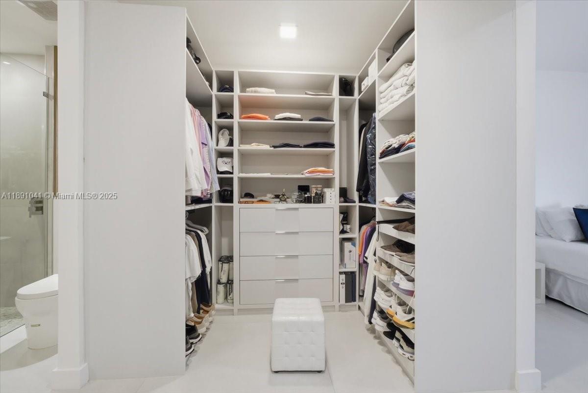1441 154th Avenue Pembroke Pines, FL 33027 - Photo 20 of 37 a view of walk in closet with empty racks
