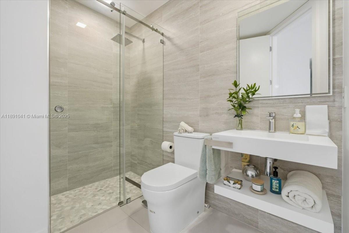 1441 154th Avenue Pembroke Pines, FL 33027 - Photo 24 of 37 a bathroom with a sink a toilet and shower
