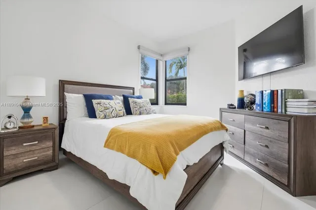 a bedroom with a bed and a flat screen tv