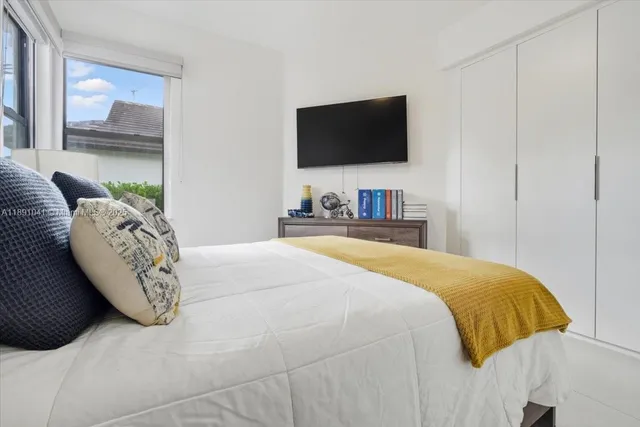 a bedroom with a bed chair and table