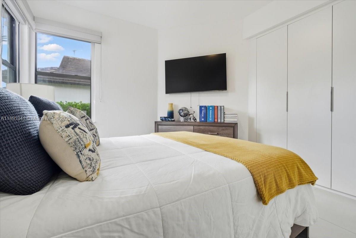 1441 154th Avenue Pembroke Pines, FL 33027 - Photo 28 of 37 a bedroom with a bed and a flat screen tv