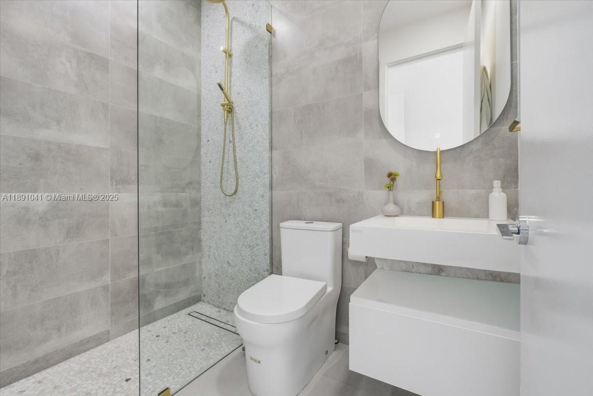 1441 154th Avenue Pembroke Pines, FL 33027 - Photo 31 of 37 a bathroom with a toilet sink and shower