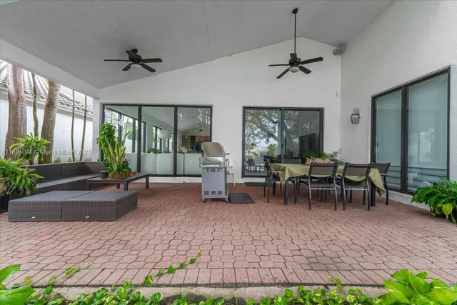 a view of an outdoor dining space with a table and chairs