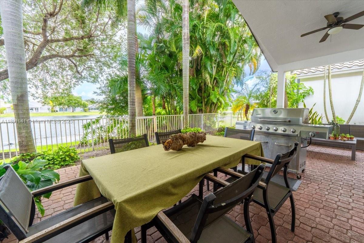 1441 154th Avenue Pembroke Pines, FL 33027 - Photo 33 of 37 a view of an outdoor dining space with a table and chairs