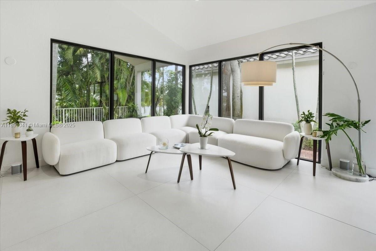 1441 154th Avenue Pembroke Pines, FL 33027 - Photo 8 of 37 a living room with furniture and a large window