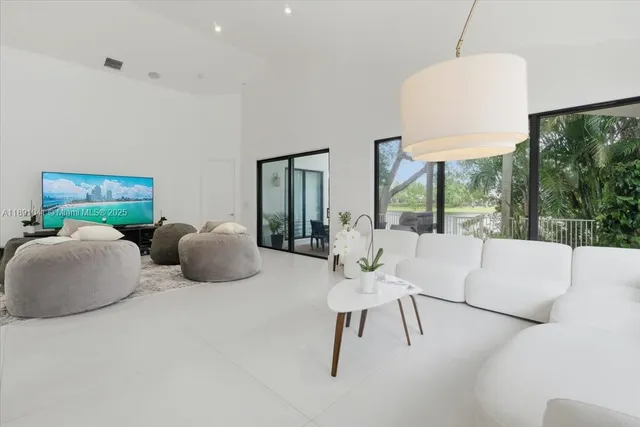 a living room with fireplace furniture and a large window