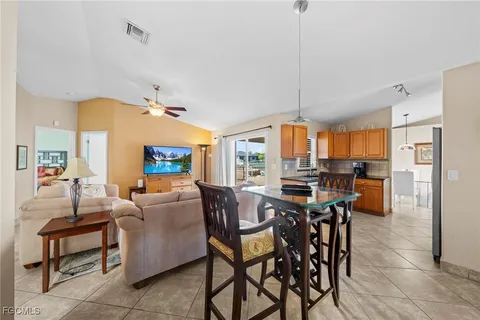 a bathroom with a granite countertop sink a toilet a mirror and a shower