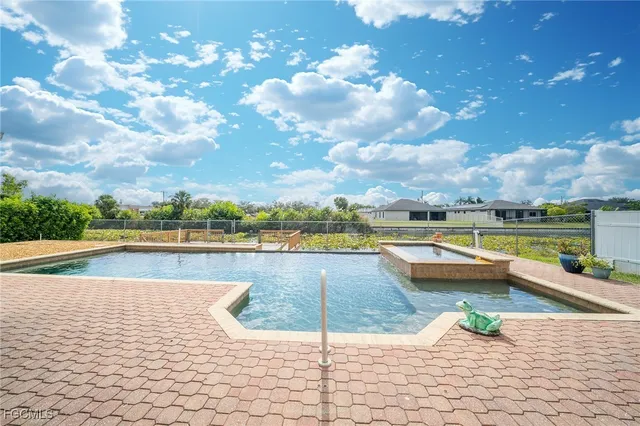 a view of a swimming pool and lounge chair