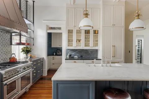 a kitchen with stainless steel appliances granite countertop a stove a sink and a microwave