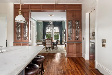 a kitchen with stainless steel appliances a stove and white cabinets