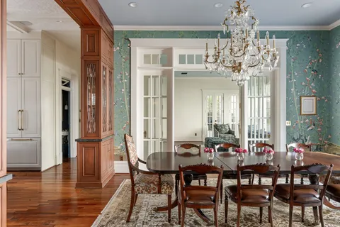 a view of a livingroom with furniture wooden floor and windows