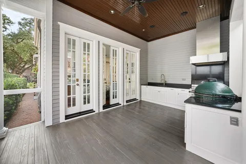 a living room with furniture large window and wooden floor
