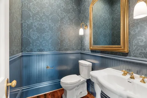 a kitchen with stainless steel appliances granite countertop a stove and a wooden floors