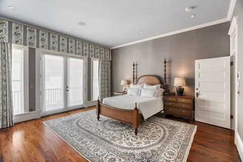 a living room with a bed furniture and a window