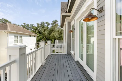 a view of a pathway of a house with wooden floor and fence