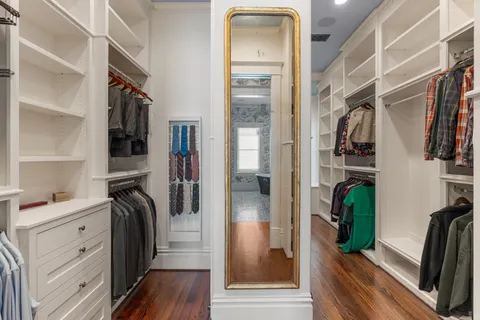 a view of walk in closet with clothes and shoes