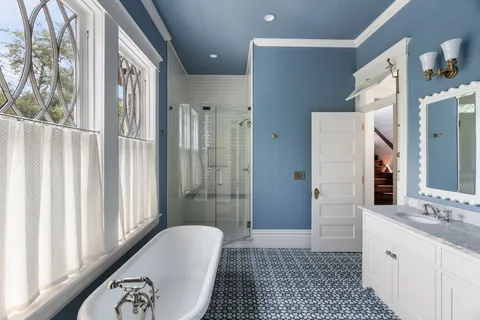 a bathroom with a granite countertop sink a mirror and a shower