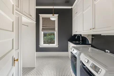 a kitchen with a sink a stove and cabinets