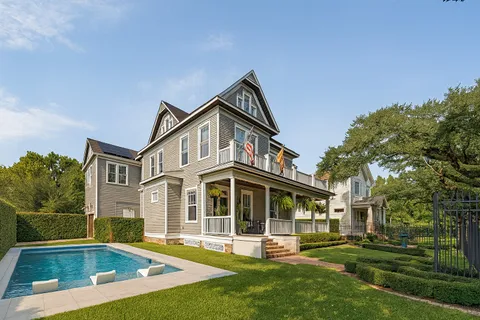 a view of a house with a yard and potted plants