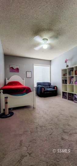 548 South Sanders Street Ridgecrest, CA 93555 - Photo 21 of 29 a bedroom with a bed and a view of bedroom