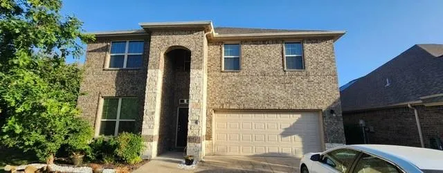 a front view of a house with glass windows and garage