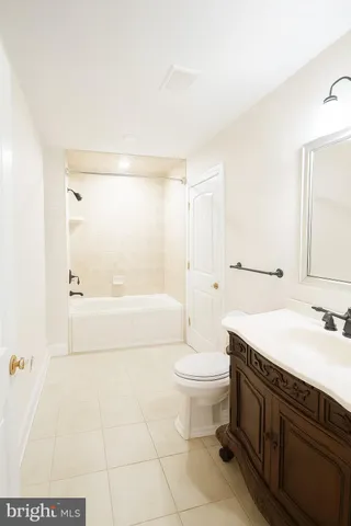 a spacious bathroom with a sink a toilet and a bathtub