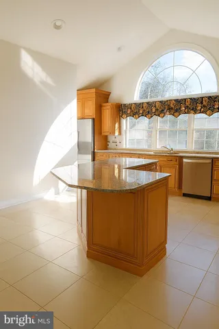 a view of kitchen with stainless steel appliances granite countertop a sink and a stove