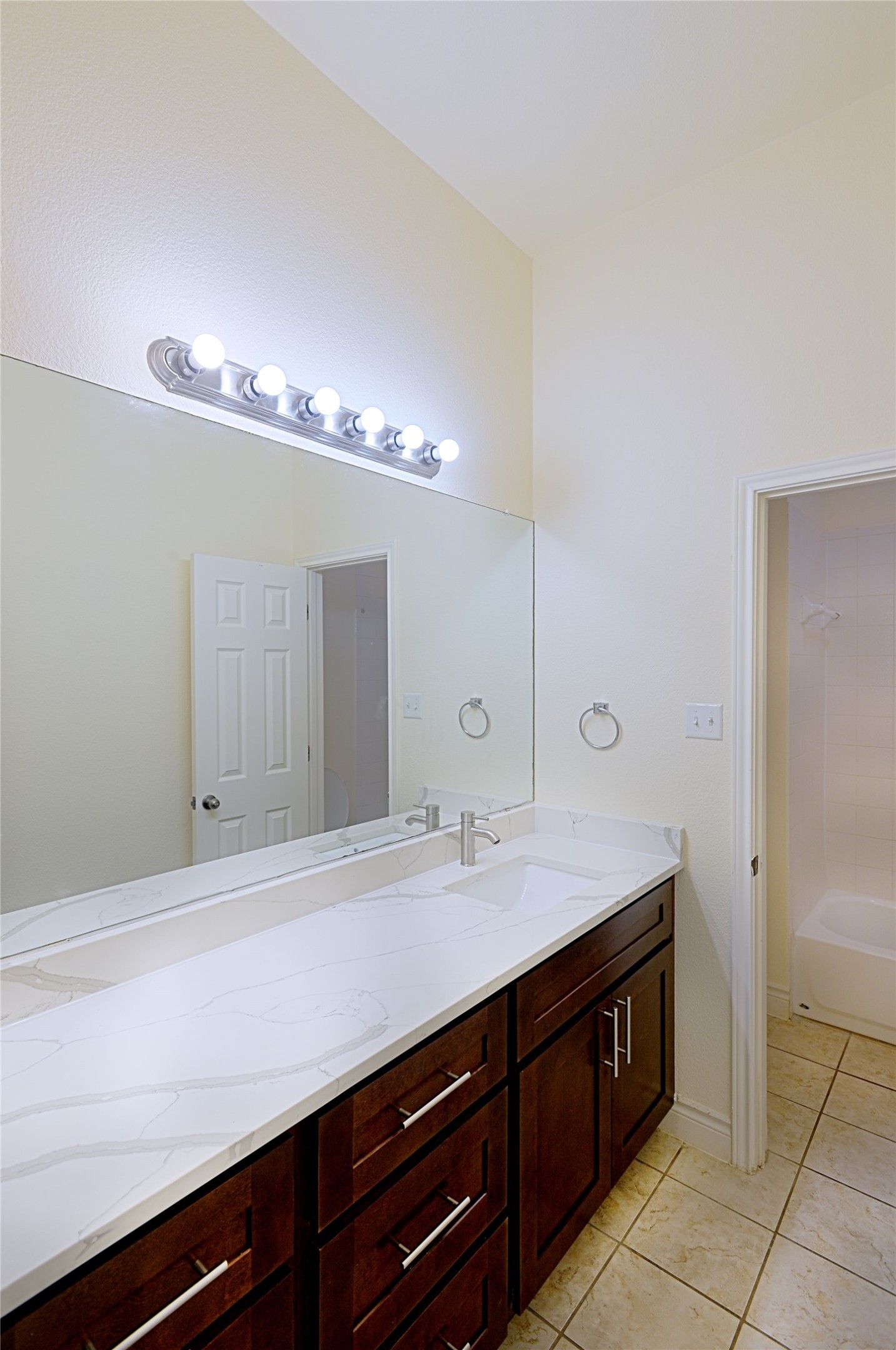 2129 Dry Tortugas Trail Austin, TX 78747 - Photo 19 of 38 a bathroom with a sink a vanity and a large mirror