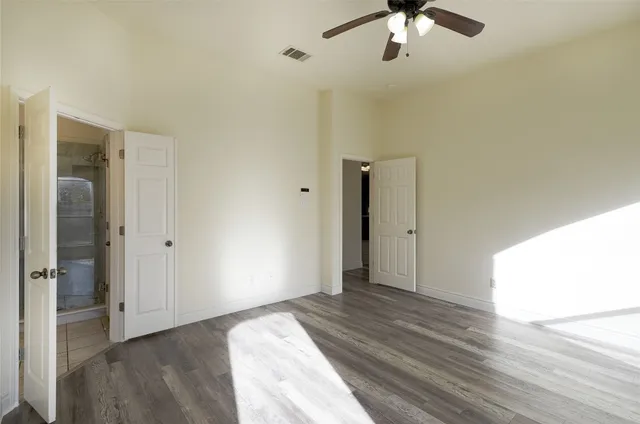 a view of empty room with wooden floor