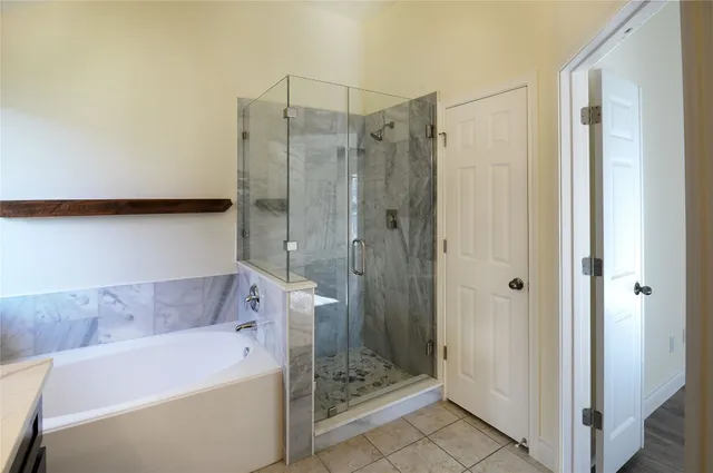 a bathroom with a tub a sink and shower