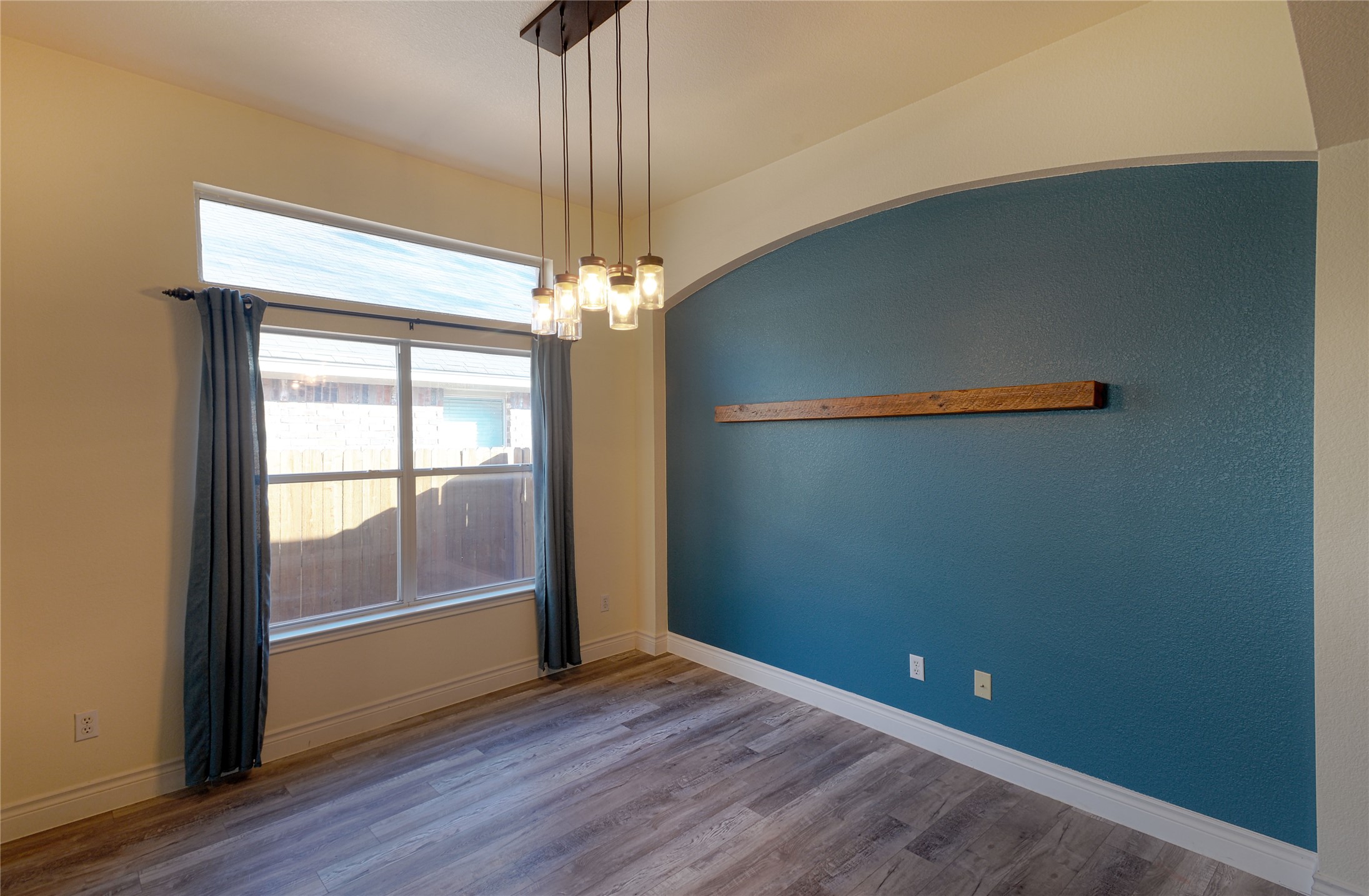 2129 Dry Tortugas Trail Austin, TX 78747 - Photo 5 of 38 a view of an empty room with wooden floor and a window