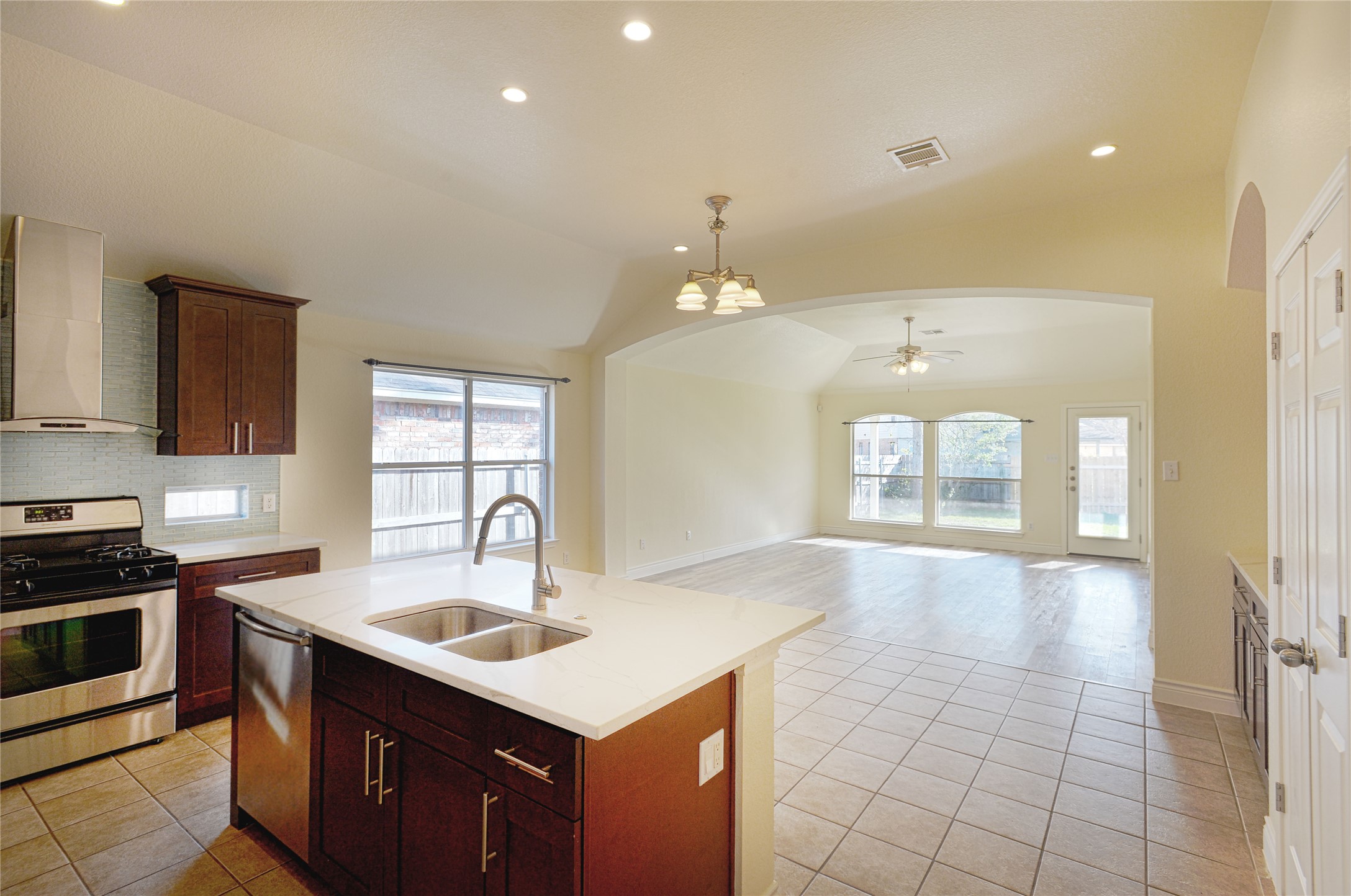 2129 Dry Tortugas Trail Austin, TX 78747 - Photo 8 of 38 a kitchen with a sink a stove and cabinets
