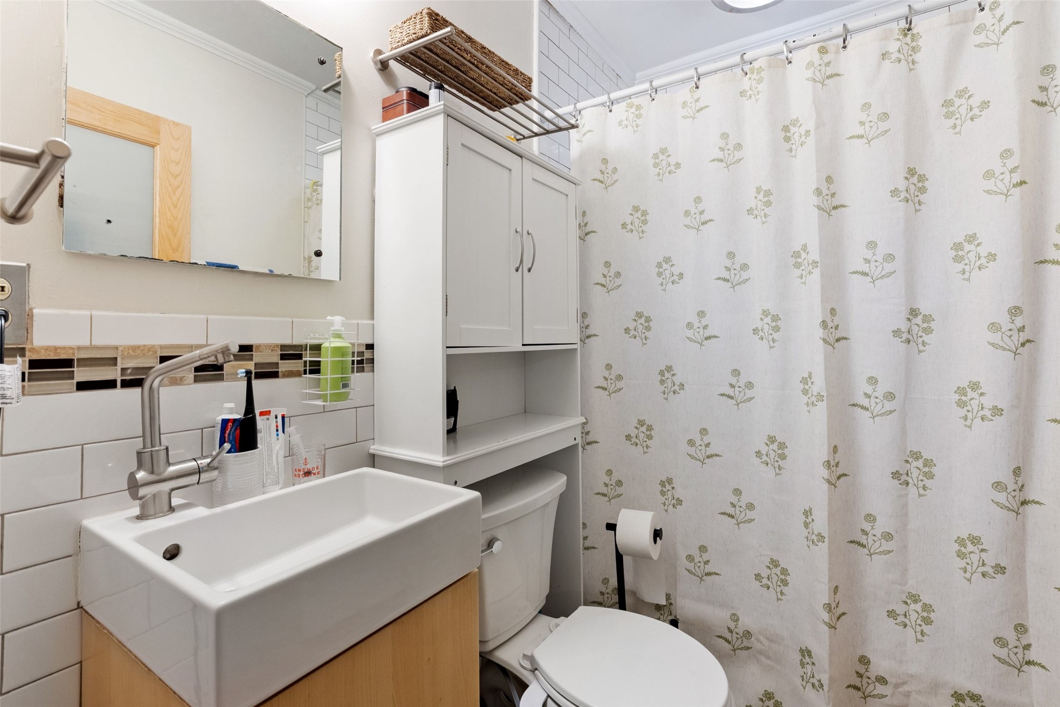 412 West Croslin Street Austin, TX 78752 - Photo 13 of 36 A compact bathroom offers functional design with contemporary fixtures and convenient storage solutions.