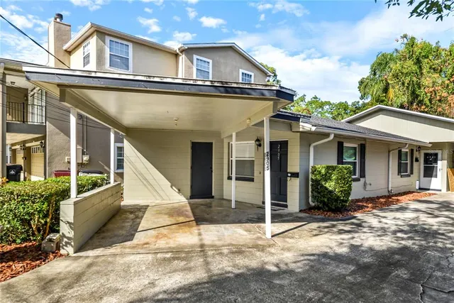 a view of a house with backyard and sitting area