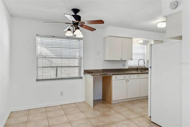 a kitchen with a sink cabinets and window