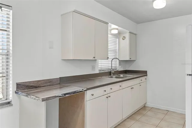 a kitchen with a sink and cabinets